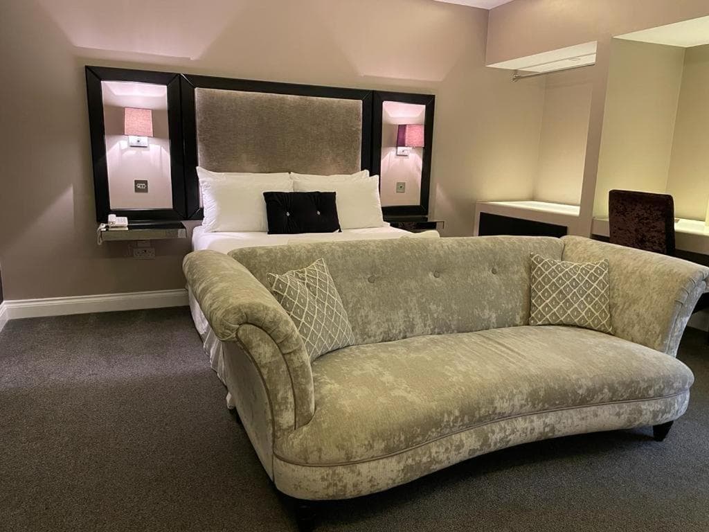 Luxury suite at The Limes Hotel — velvet chaise longue and king bed